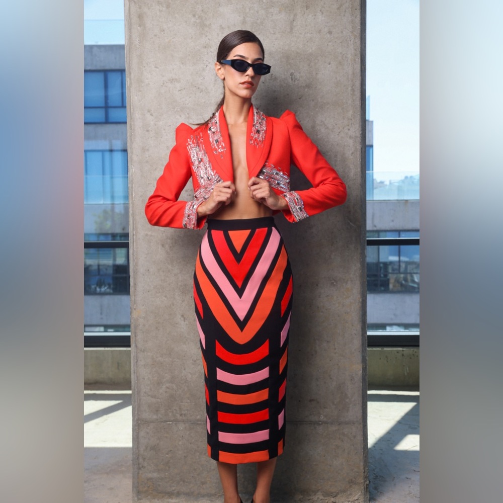 Eccentric red skirt made of crepe fabric with a red cropped blazer.